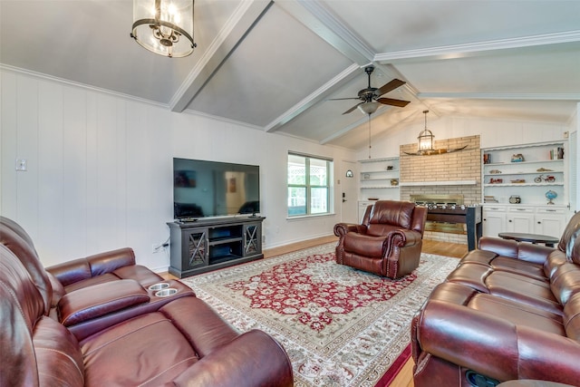 living room with ceiling fan, vaulted ceiling with beams, a fireplace, wood-type flooring, and built in shelves