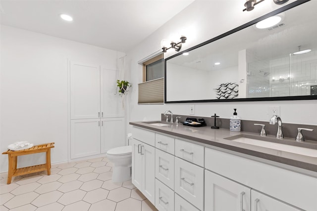 bathroom featuring vanity, an enclosed shower, and toilet