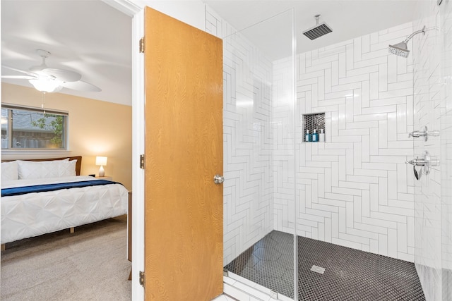 bathroom with ceiling fan and tiled shower