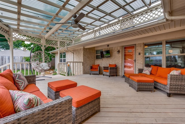 wooden terrace featuring an outdoor living space, ceiling fan, and a pergola