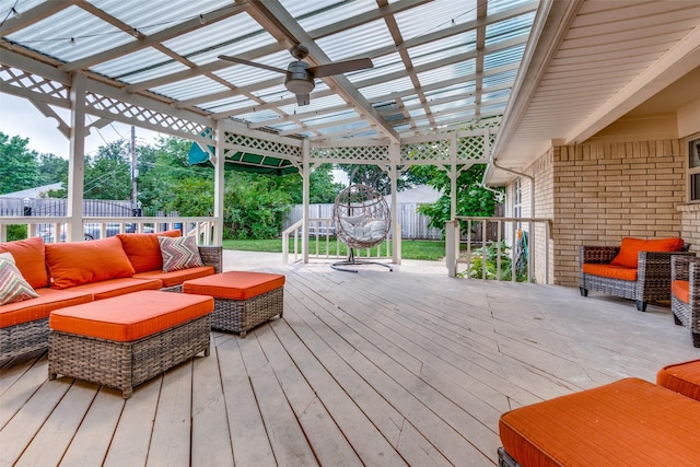 wooden deck featuring ceiling fan, an outdoor hangout area, and a pergola