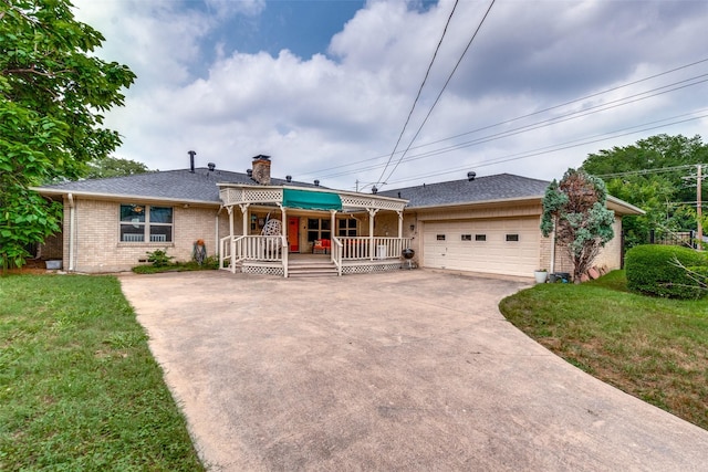 ranch-style home featuring a garage, covered porch, and a front lawn