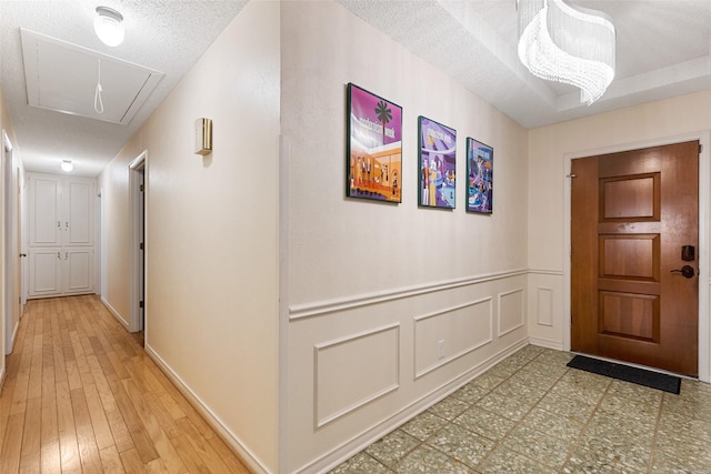 hallway with wood-type flooring and a textured ceiling