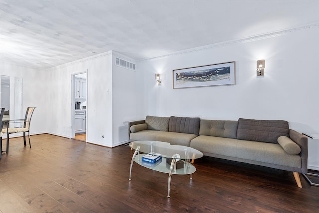 living room featuring crown molding and dark hardwood / wood-style floors