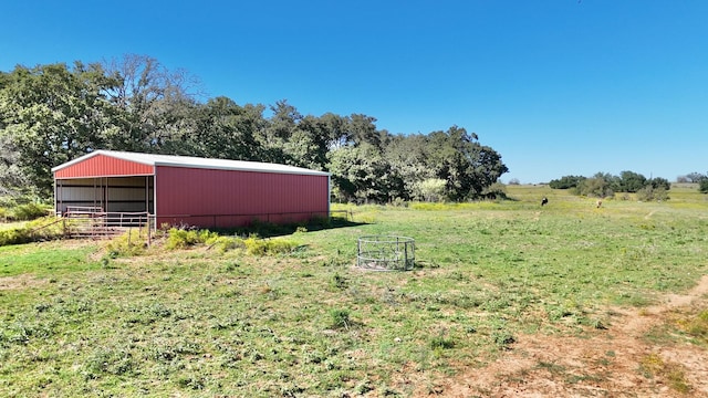 view of yard featuring a rural view and an outdoor structure