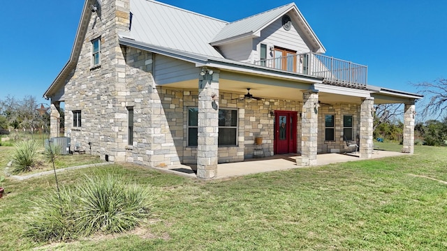 view of front facade with a balcony, central AC unit, ceiling fan, a patio area, and a front lawn