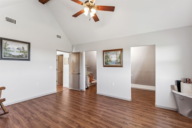 unfurnished living room featuring dark wood-type flooring, ceiling fan, and high vaulted ceiling