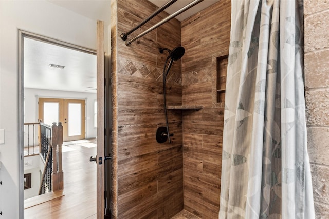 bathroom with french doors and a shower with shower curtain