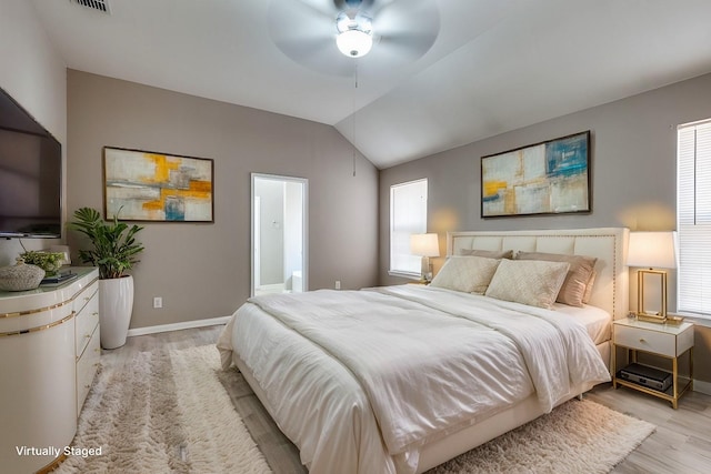 bedroom with ceiling fan, lofted ceiling, and light wood-type flooring