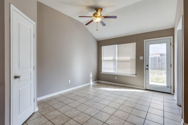 tiled spare room featuring ceiling fan and vaulted ceiling