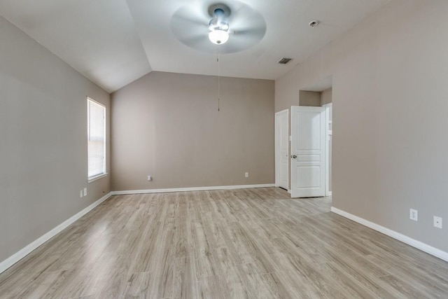 empty room featuring vaulted ceiling, ceiling fan, and light hardwood / wood-style flooring