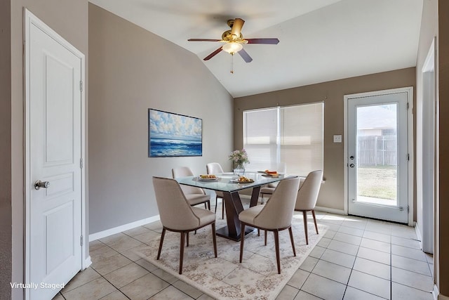 tiled dining area with vaulted ceiling and ceiling fan