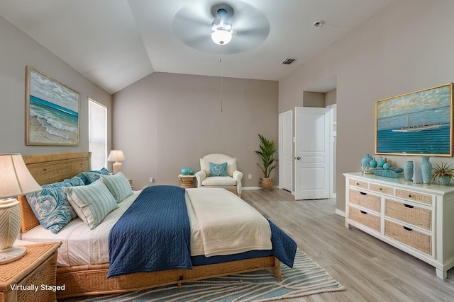 bedroom featuring ceiling fan, vaulted ceiling, and light wood-type flooring