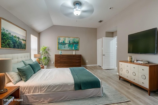 bedroom featuring ceiling fan, vaulted ceiling, and light hardwood / wood-style flooring