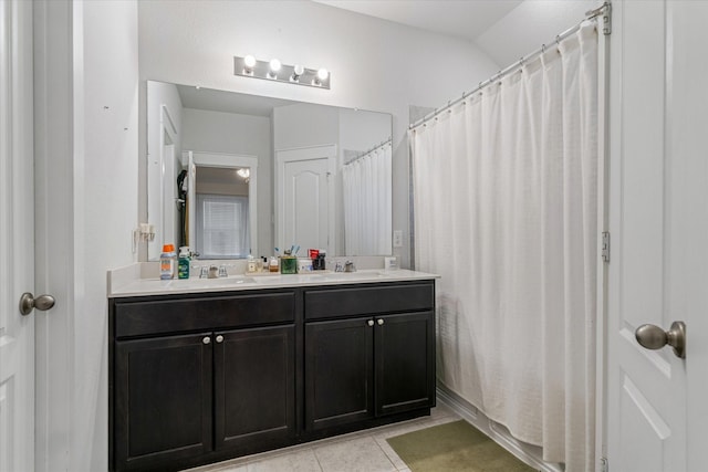 bathroom with vanity, lofted ceiling, tile patterned floors, and walk in shower