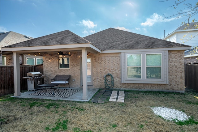 back of property featuring a lawn, ceiling fan, and a patio area