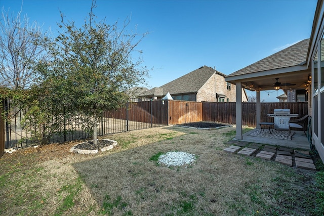 view of yard with ceiling fan and a patio