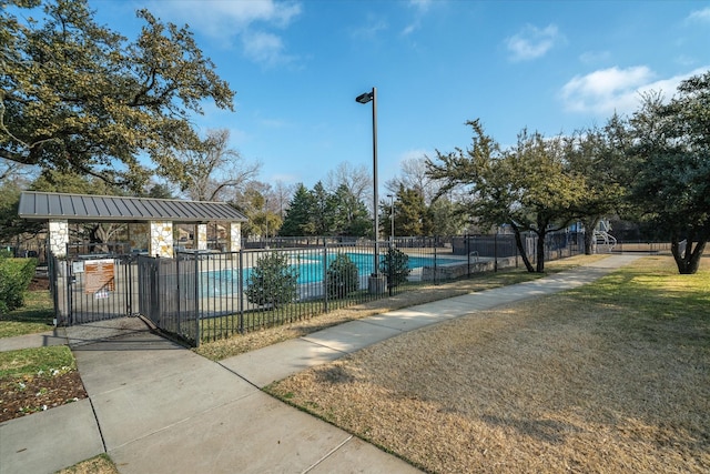 view of swimming pool with a gazebo and a lawn