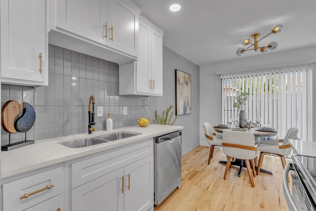 kitchen featuring sink, tasteful backsplash, light hardwood / wood-style flooring, stainless steel dishwasher, and white cabinets