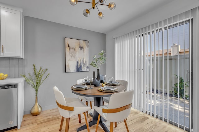 dining room with an inviting chandelier and light hardwood / wood-style floors