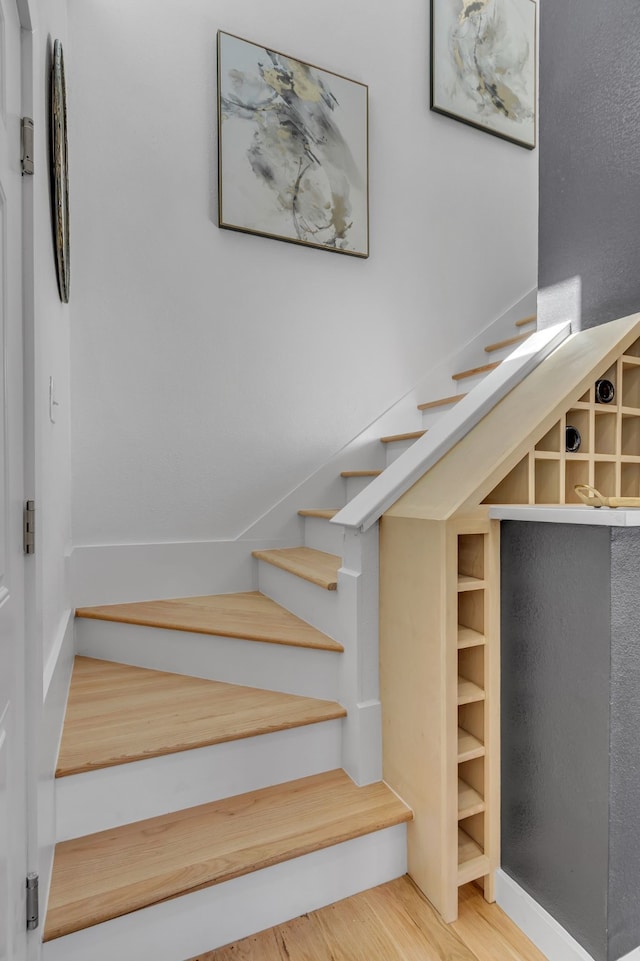 stairs with hardwood / wood-style floors