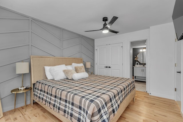 bedroom featuring light hardwood / wood-style flooring, a closet, and ceiling fan