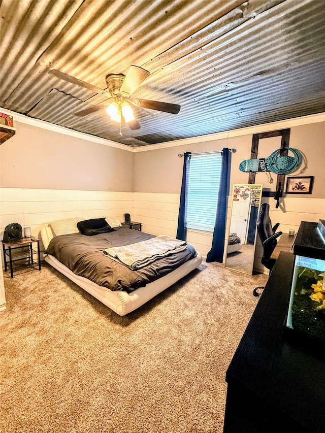 bedroom with wood ceiling, ceiling fan, ornamental molding, and carpet flooring