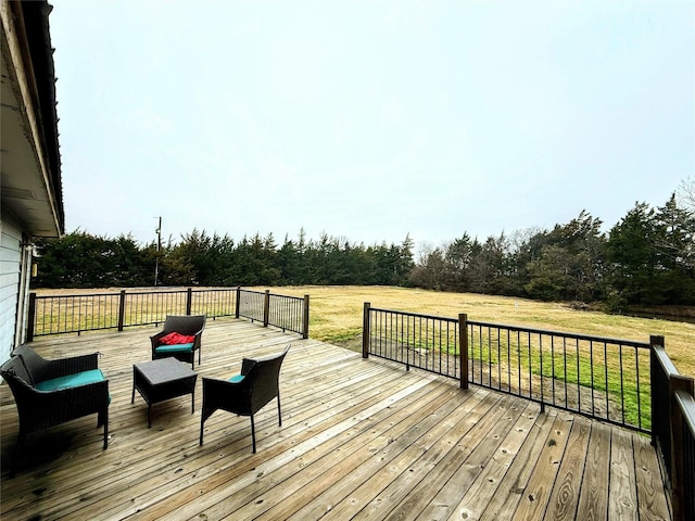 wooden deck featuring a lawn