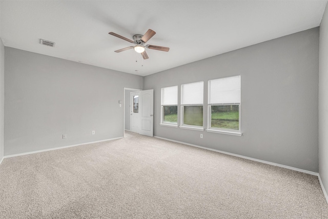 unfurnished room featuring ceiling fan and carpet