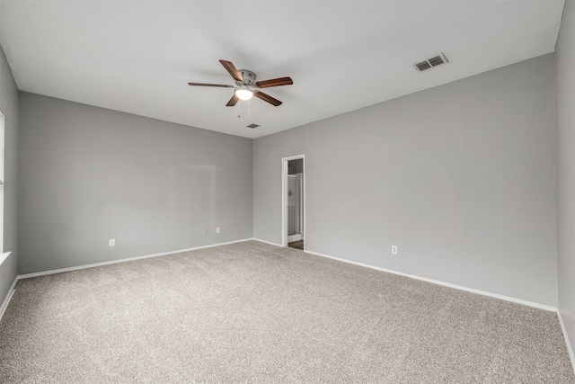 carpeted spare room featuring ceiling fan