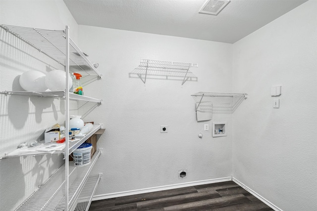 laundry room featuring gas dryer hookup, dark hardwood / wood-style floors, hookup for an electric dryer, and hookup for a washing machine