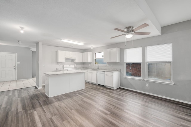 kitchen featuring range, white cabinetry, a center island, white dishwasher, and dark hardwood / wood-style flooring