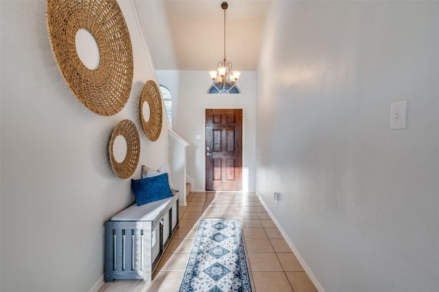 hall with light tile patterned flooring and an inviting chandelier