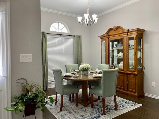 dining area with ornamental molding, a notable chandelier, and dark hardwood / wood-style flooring