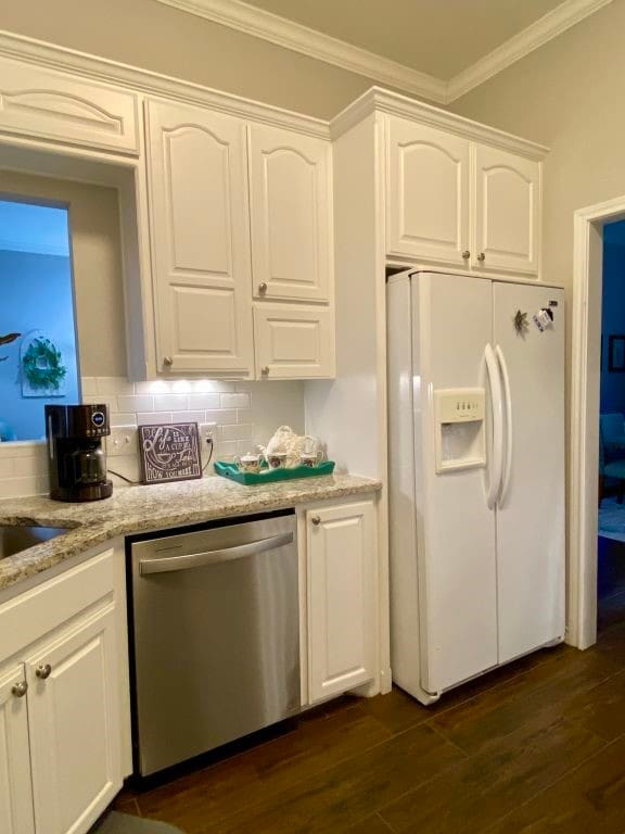 kitchen featuring white cabinetry, dishwasher, white fridge with ice dispenser, crown molding, and dark wood-type flooring