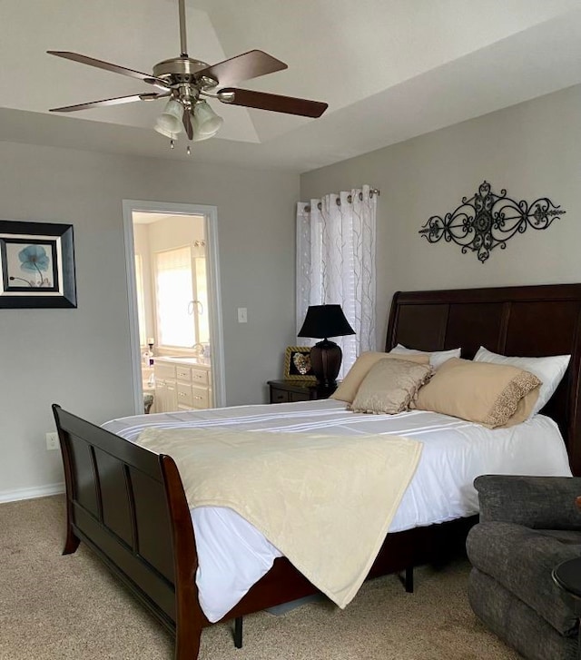 carpeted bedroom featuring ensuite bath and ceiling fan