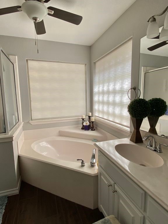 bathroom with vanity, separate shower and tub, and hardwood / wood-style floors