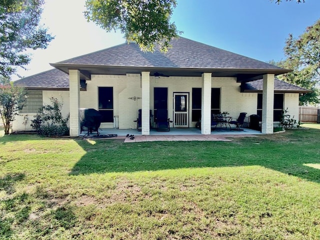 back of house with a patio and a yard