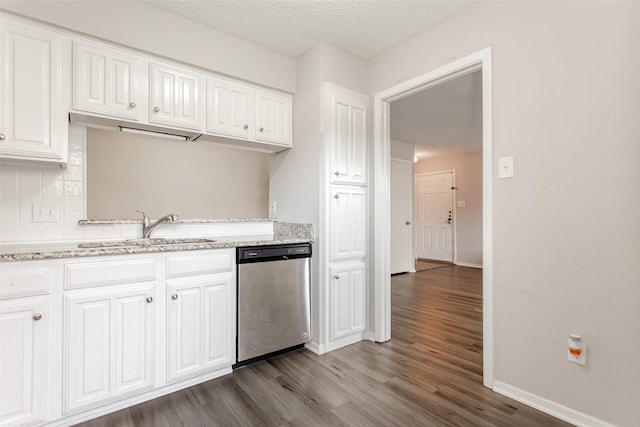 kitchen featuring white cabinetry, dishwasher, sink, dark hardwood / wood-style flooring, and light stone countertops