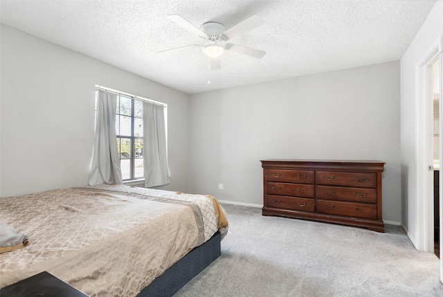 carpeted bedroom featuring a textured ceiling and ceiling fan