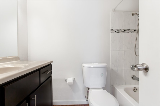 full bathroom with vanity, tiled shower / bath combo, and toilet