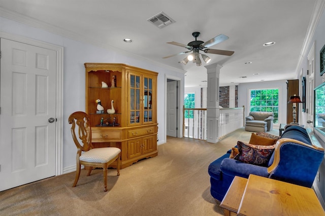 living room featuring ornamental molding, light carpet, and ceiling fan