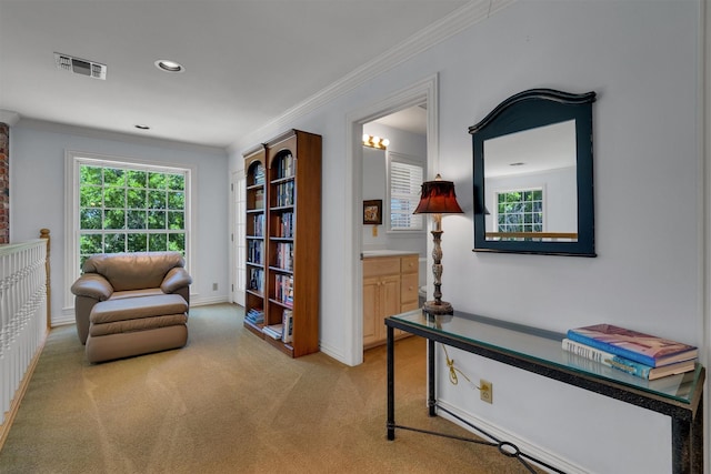 sitting room with crown molding and light carpet