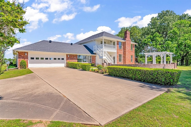 view of front facade with a garage, a pergola, a front lawn, and a balcony