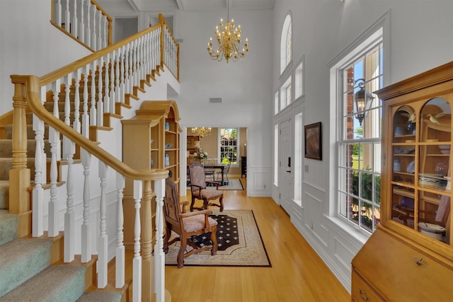 entryway featuring a chandelier and light hardwood / wood-style flooring