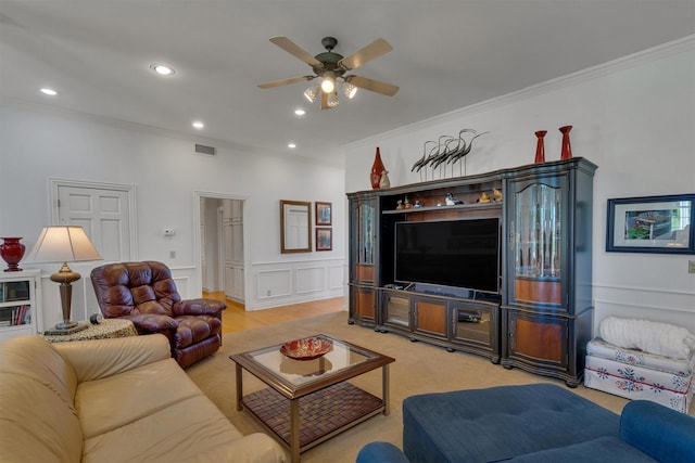 living room with crown molding, carpet floors, and ceiling fan