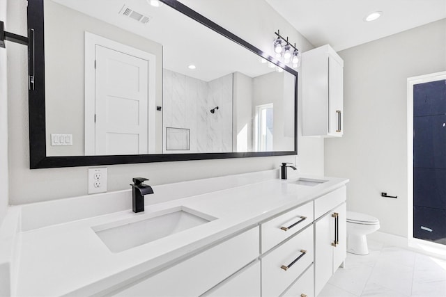 bathroom featuring vanity, toilet, and a tile shower