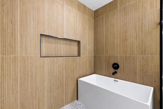 bathroom with tile walls