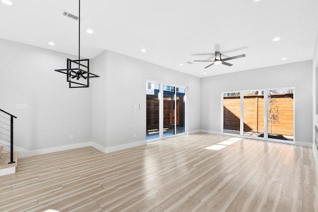 unfurnished living room featuring ceiling fan and light wood-type flooring