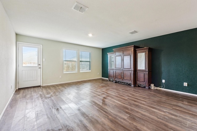 interior space with hardwood / wood-style flooring and a healthy amount of sunlight